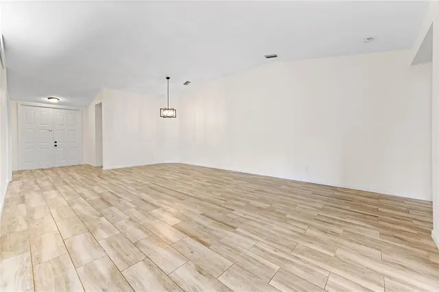 a view of a room with wooden floor and white walls