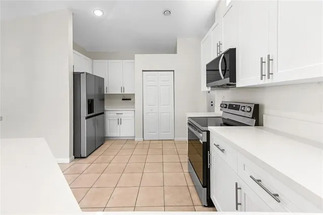 a kitchen with stainless steel appliances a refrigerator stove microwave and sink