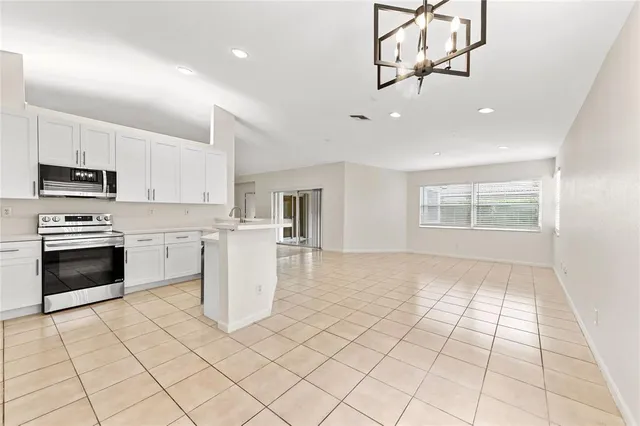 a kitchen with a stove a sink and a refrigerator
