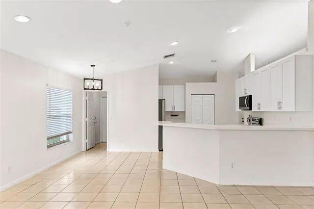 a kitchen with stainless steel appliances a refrigerator sink and cabinets