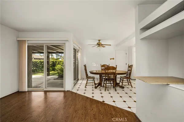a dining room with furniture a rug and wooden floor