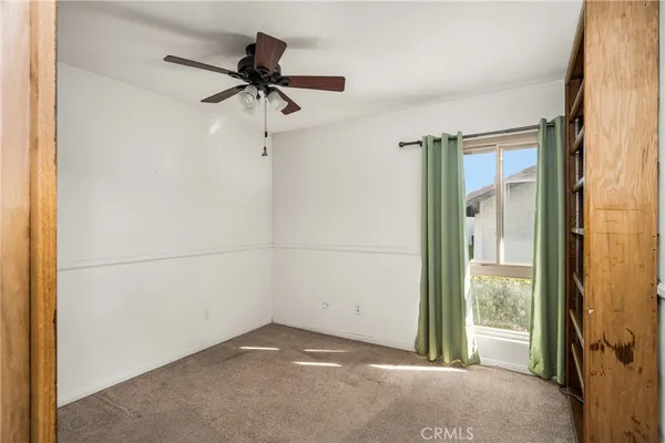 a view of empty room with ceiling fan
