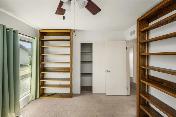 a view of walk in closet with empty racks