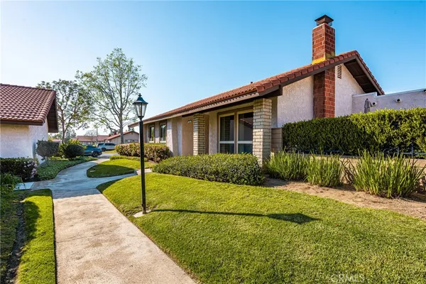 a view of a house with a yard and plants