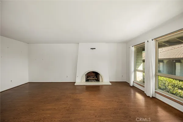 a room with a window and wooden floor