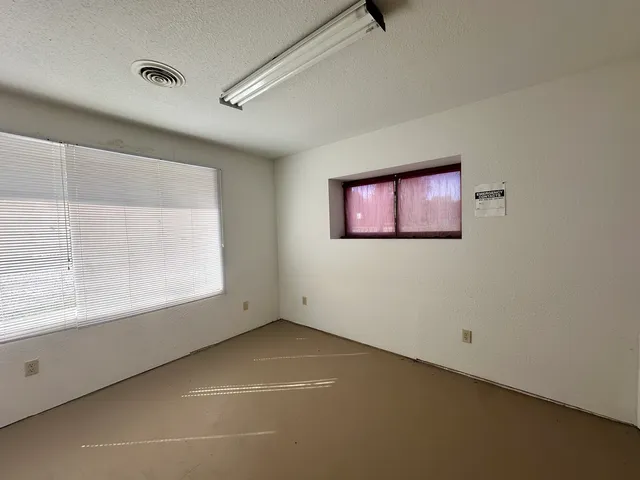 a view of a room with window and cabinet