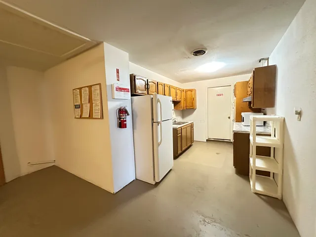 an empty room with a empty space and a ceiling fan