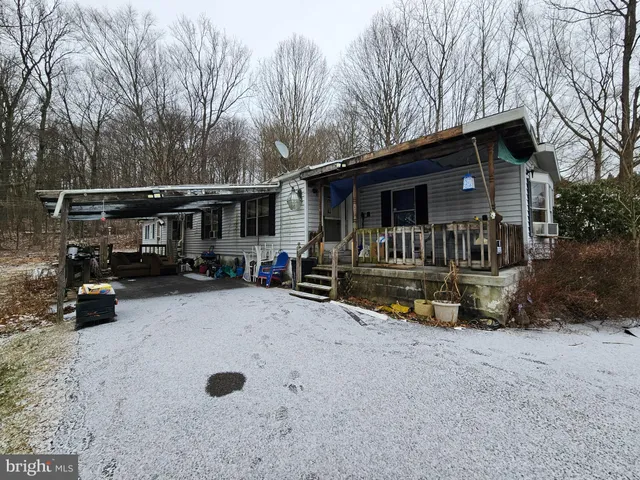 a view of house with backyard and sitting area