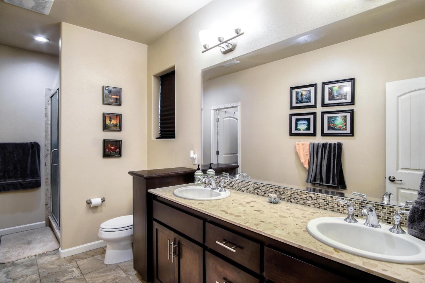 108 Springtime Circle Hollister, CA 95023 - Photo 21 of 36 a bathroom with a granite countertop toilet sink and mirror