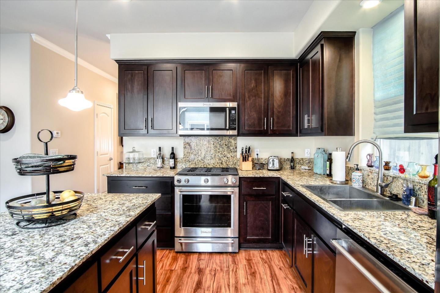 108 Springtime Circle Hollister, CA 95023 - Photo 3 of 36 a kitchen with stainless steel appliances granite countertop a sink stove and cabinets