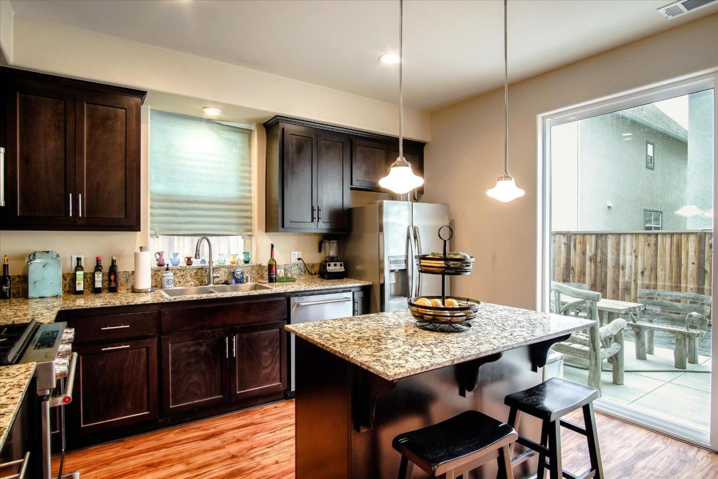 108 Springtime Circle Hollister, CA 95023 - Photo 36 of 36 a kitchen with granite countertop kitchen island stainless steel appliances a sink stove and refrigerator