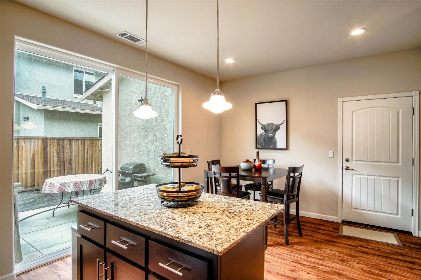 108 Springtime Circle Hollister, CA 95023 - Photo 4 of 36 a view of a kitchen area with furniture and wooden floor