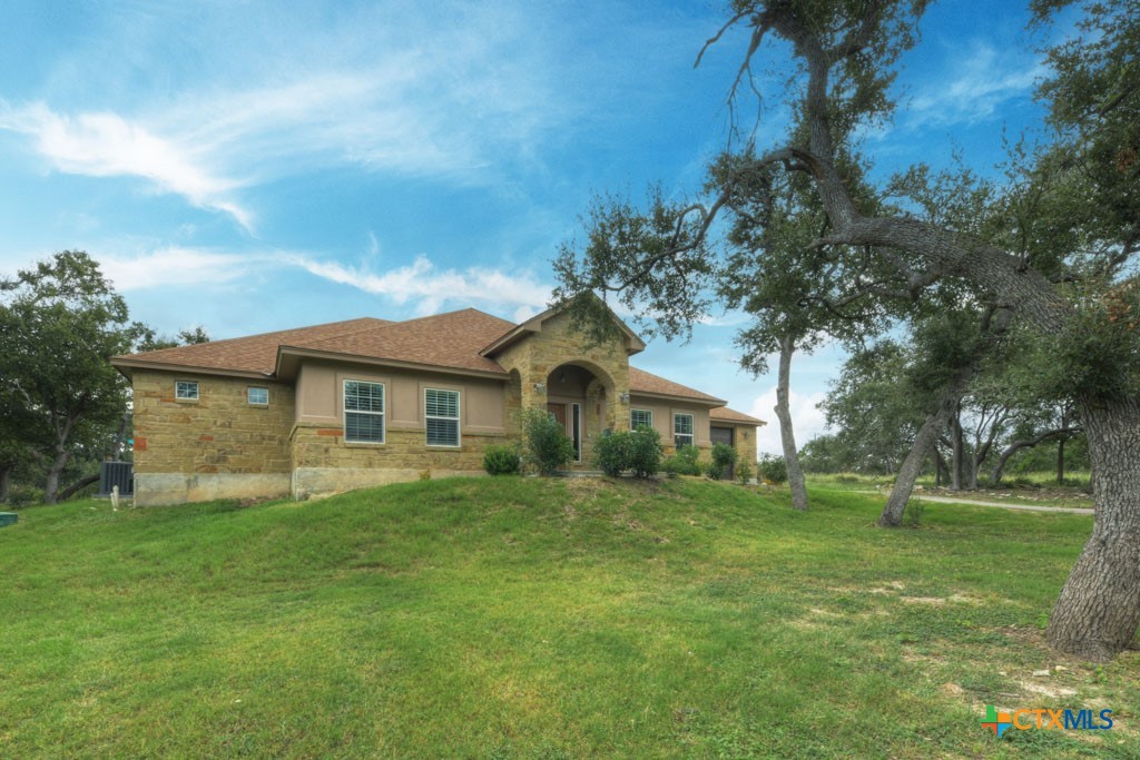 861 Rutherford Fischer, TX 78623 - Photo 2 of 38 Beautiful HILL COUNTRY HOME on 1+ACRE. Custom Built w/WIDE DOOR/HALLWAYS for EASY MOBILITY, RV pad with Septic connection, Greenhouse, Composite Decking, and Above Ground Pool! . LOW HOA & GATED COMMUNITY.