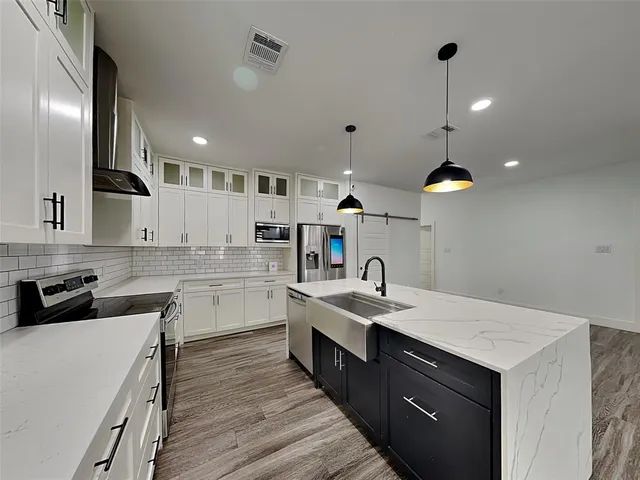 a kitchen with a sink stove and cabinets