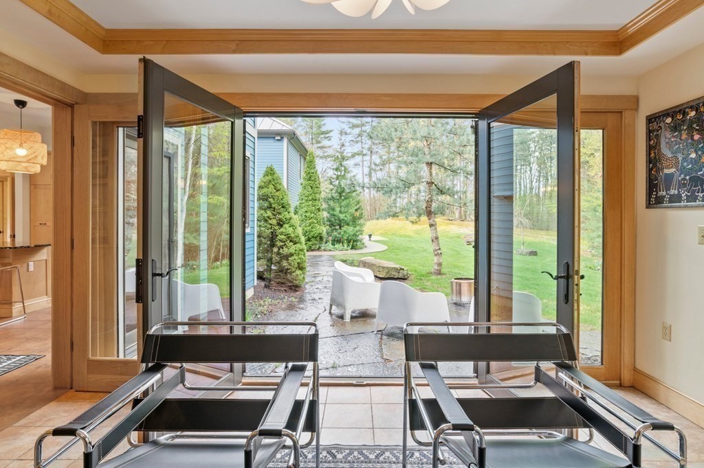 62 Buffam Road Pelham, MA 01002 - Photo 16 of 42 a living room with a large window and a table