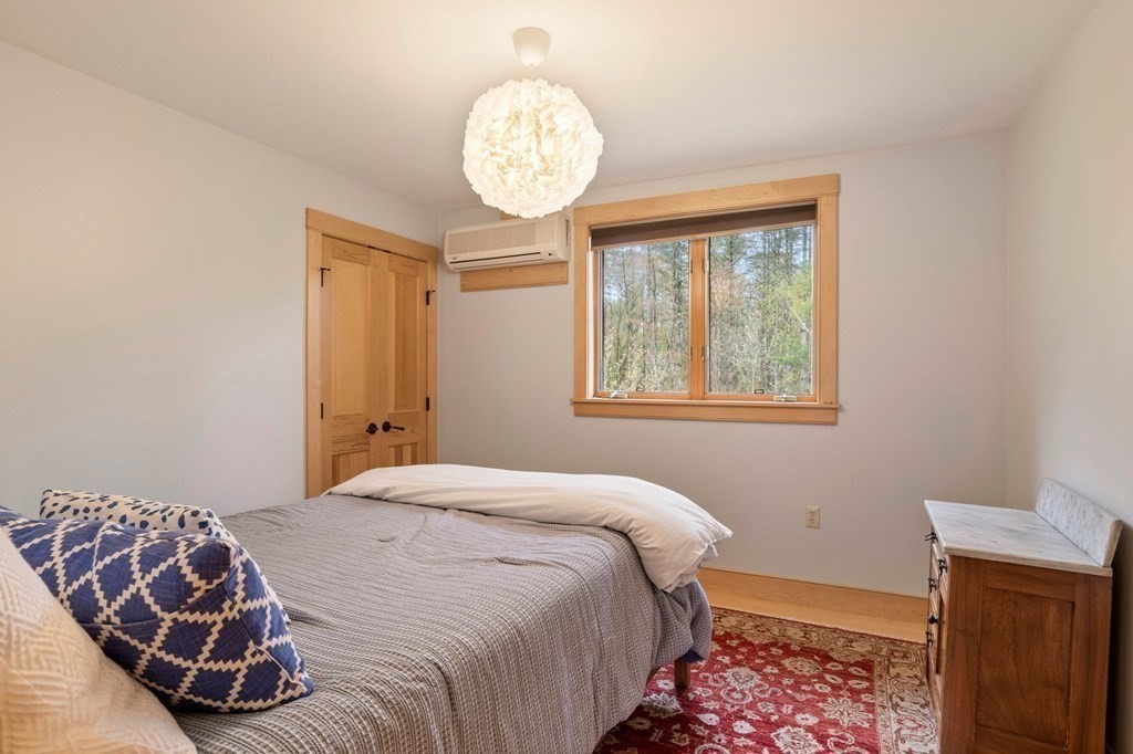 62 Buffam Road Pelham, MA 01002 - Photo 32 of 42 a bedroom with a bed and a window