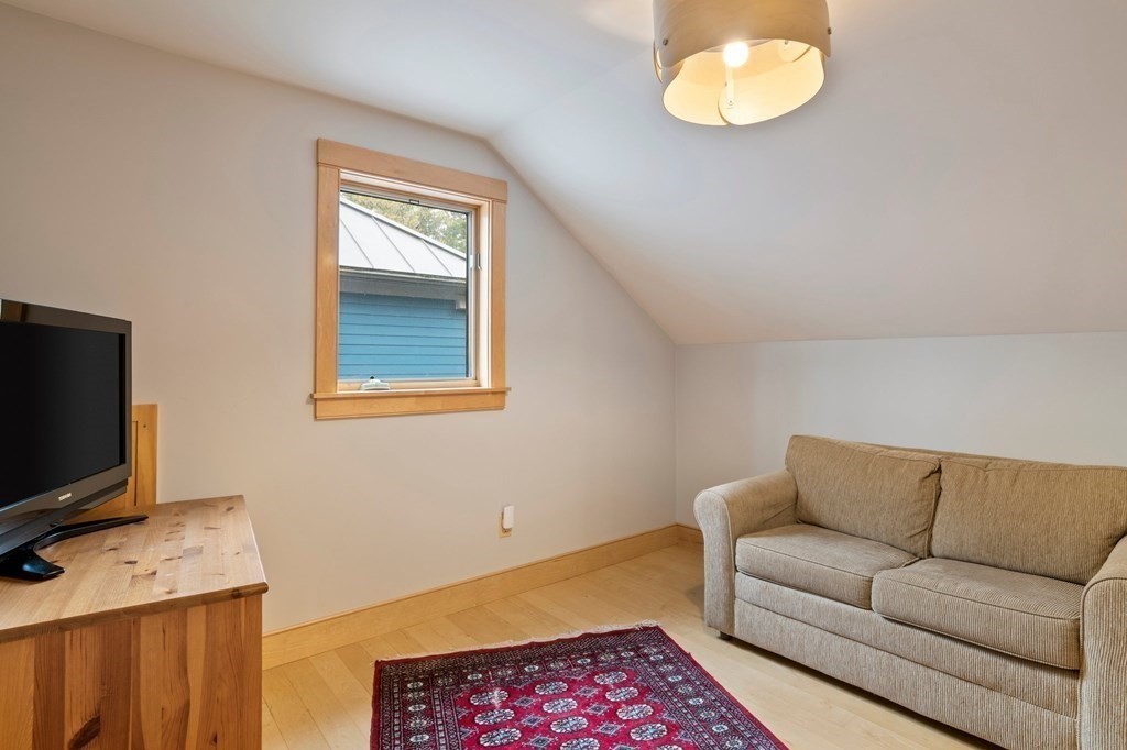62 Buffam Road Pelham, MA 01002 - Photo 33 of 42 a living room with furniture and a flat screen tv