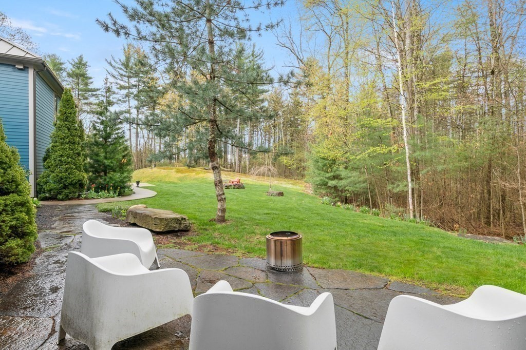 62 Buffam Road Pelham, MA 01002 - Photo 38 of 42 a view of a patio with couches chairs and a yard