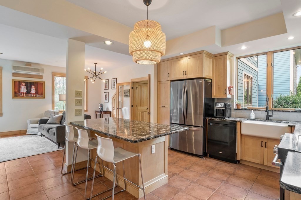 62 Buffam Road Pelham, MA 01002 - Photo 9 of 42 a kitchen with stainless steel appliances granite countertop a table chairs stove and refrigerator