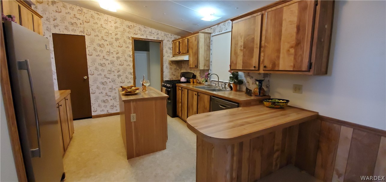 3469 Kayenta Road Golden Valley, AZ 86413 - Photo 14 of 49 a kitchen with a sink a stove and a refrigerator