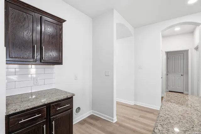 a kitchen with granite countertop stainless steel appliances and wooden cabinets