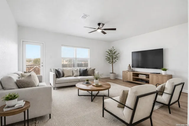 a living room with furniture and a flat screen tv