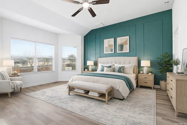 a spacious bedroom with a bed and a large window