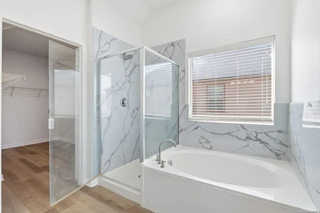 a bathroom with a bathtub and a shower