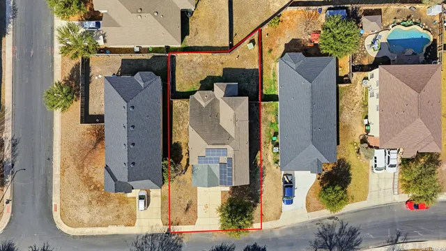 an aerial view of residential houses with outdoor space