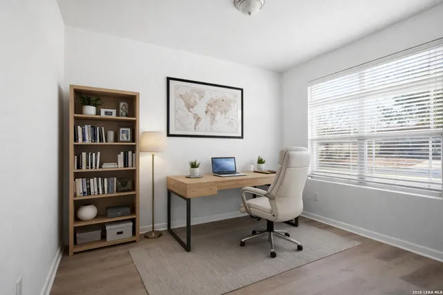 a view of a workspace with a window and cabinet