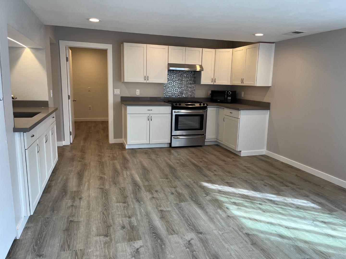 a kitchen with granite countertop a sink and cabinets