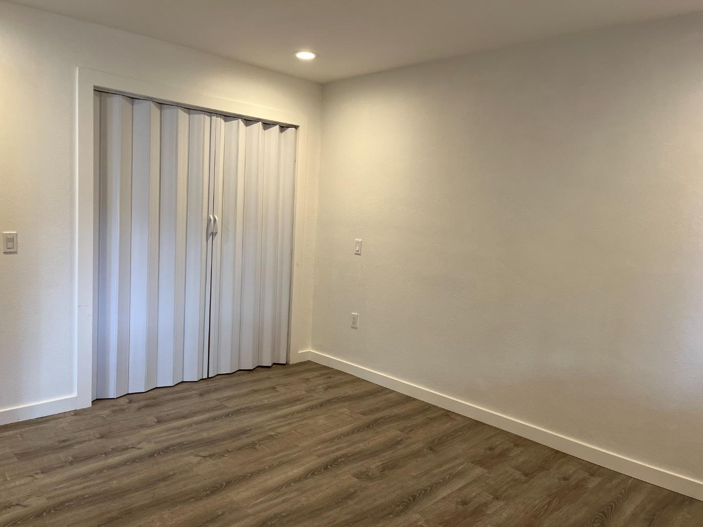 5 Malavear Court, Unit INLAW Pacifica, CA 94044 - Photo 8 of 13 a view of a room with wooden floor