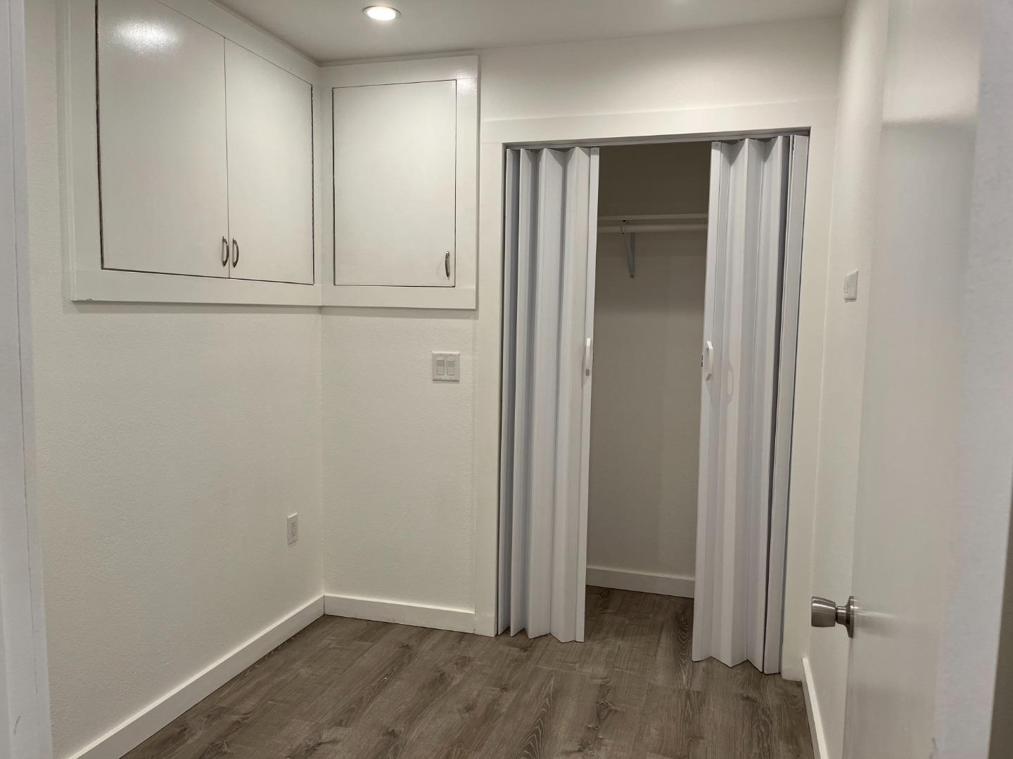 5 Malavear Court, Unit INLAW Pacifica, CA 94044 - Photo 9 of 13 an empty room with wooden floor