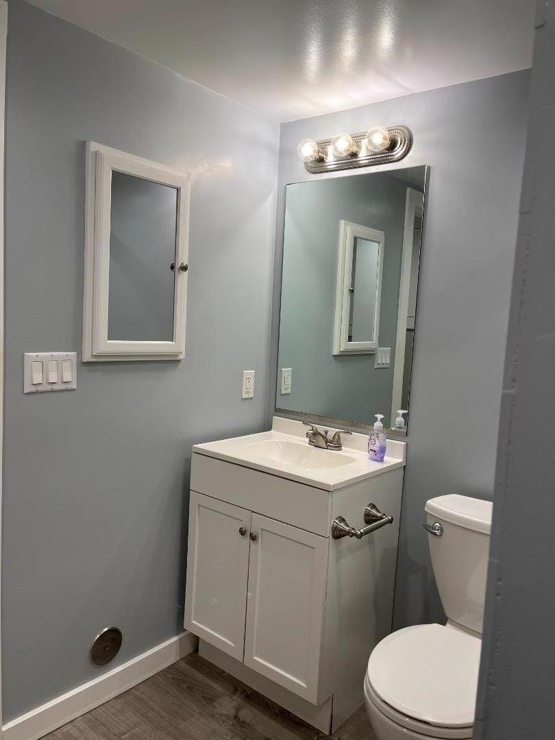 5 Malavear Court, Unit INLAW Pacifica, CA 94044 - Photo 10 of 13 a bathroom with a toilet sink and mirror