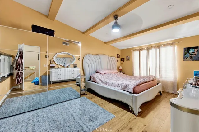 a spacious bedroom with a bed a table and chair