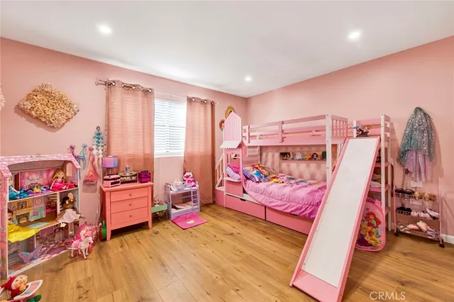 a bedroom with furniture and a wooden floor