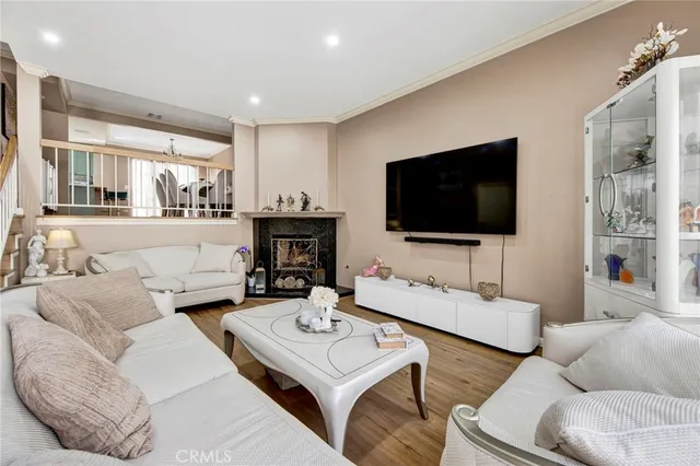 a living room with furniture a flat screen tv and a fireplace