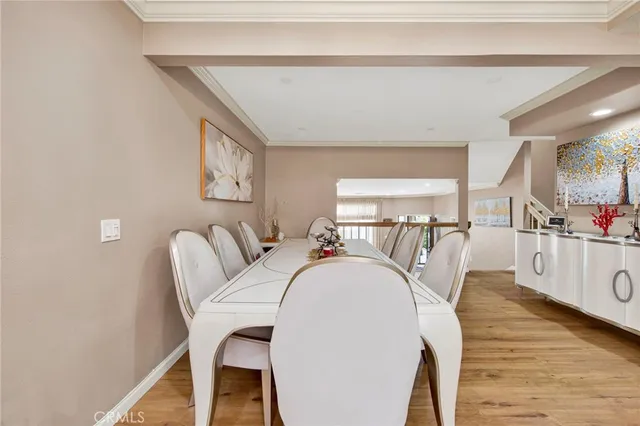 a dining room with furniture and wooden floor