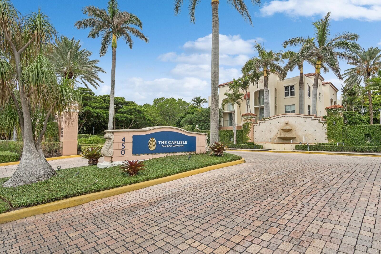 450 East Ocean Avenue, Unit 519 Lantana, FL 33462 - Photo 1 of 18 a view of a white house with a yard and palm trees