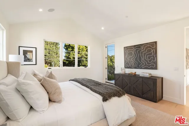 a bedroom with a large bed and a couch