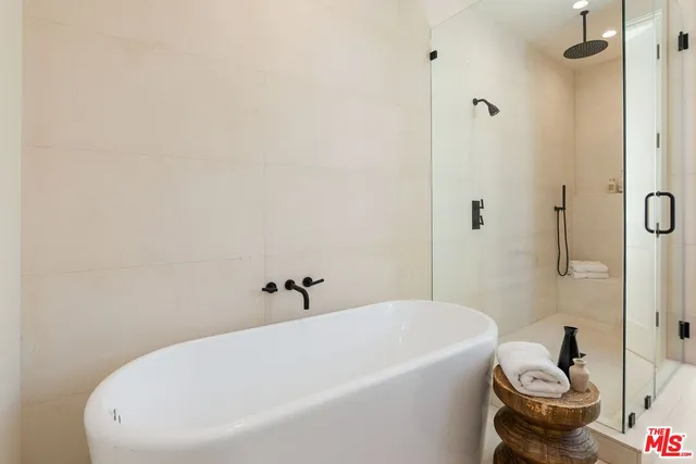 a white bath tub sitting next to a white toilet