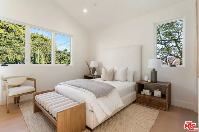 a bedroom with a bed and a couch