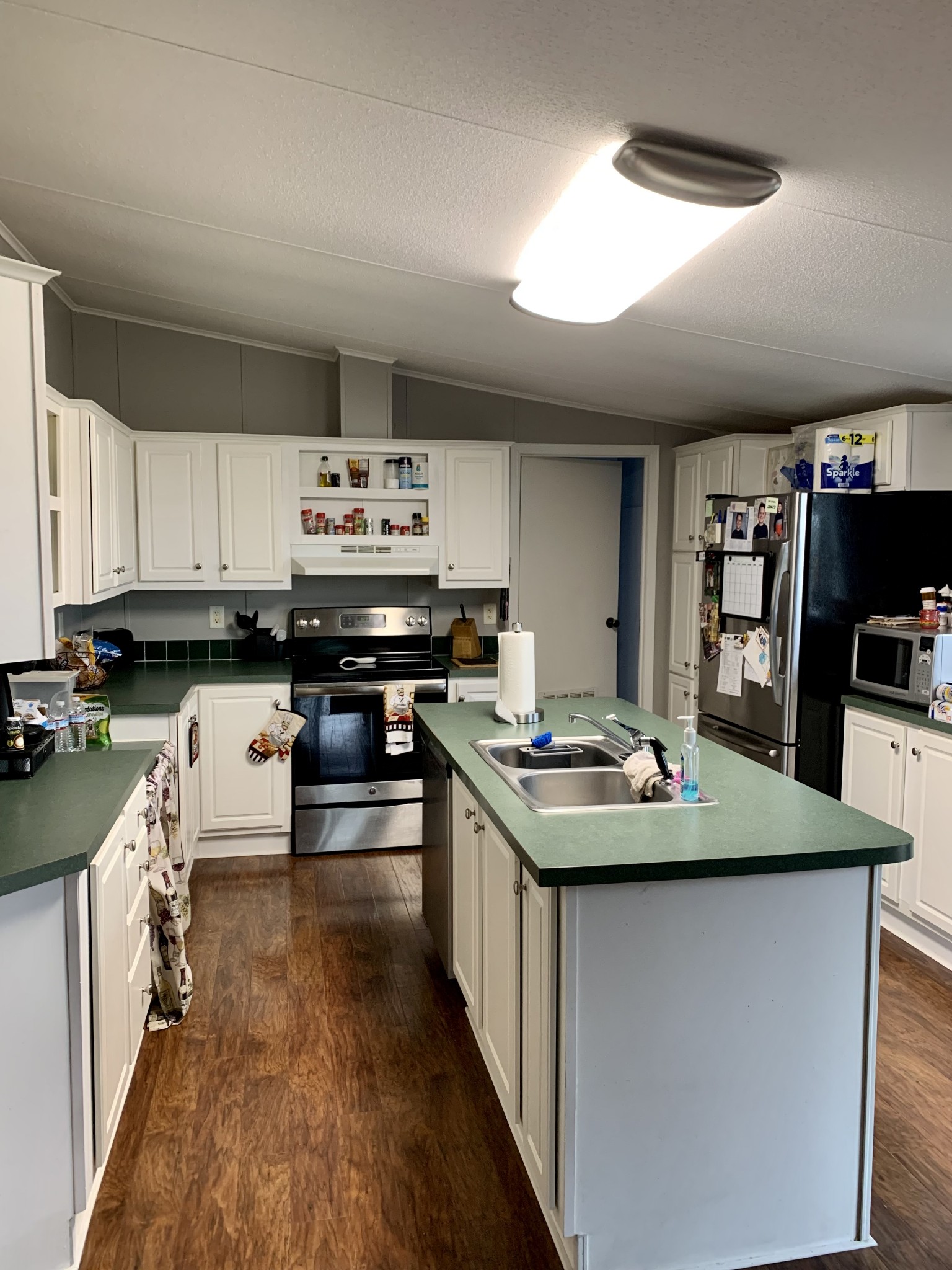 1145 Boyd Road Lafayette, TN 37083 - Photo 5 of 17 a kitchen with kitchen island a sink stove and cabinets