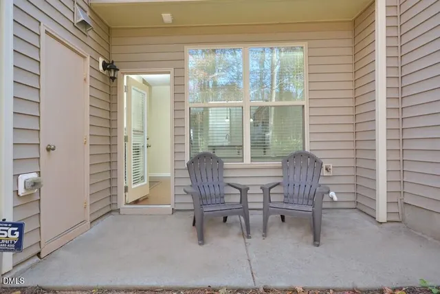 a view of a room with a table and chairs