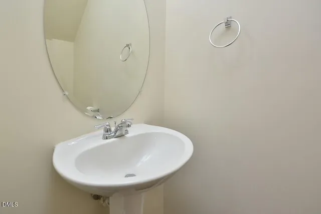 a bathroom with a sink and mirror