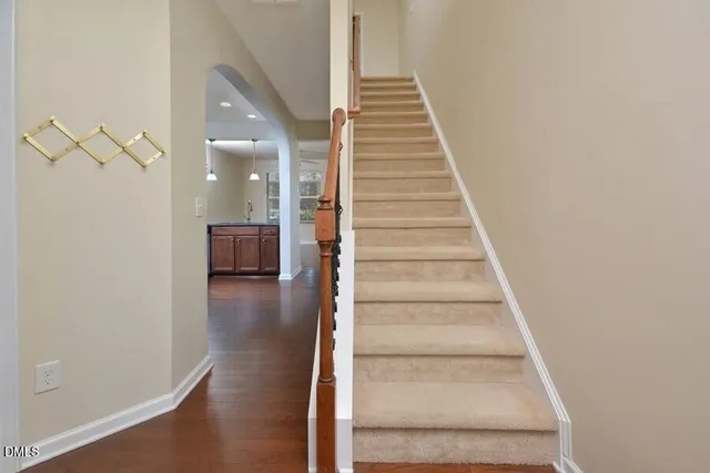 a view of a hallway with wooden floor and entryway