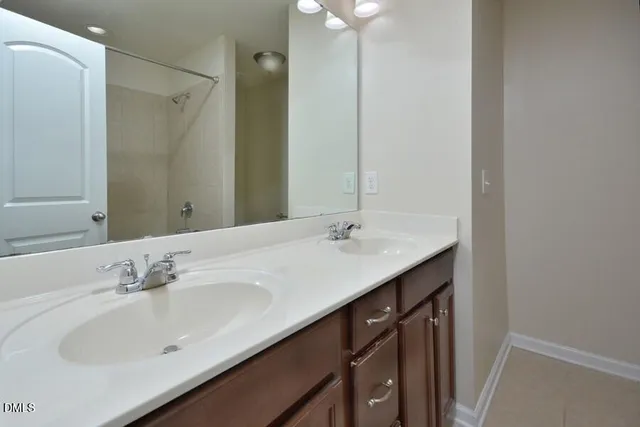 a bathroom with a double vanity sink mirror and double