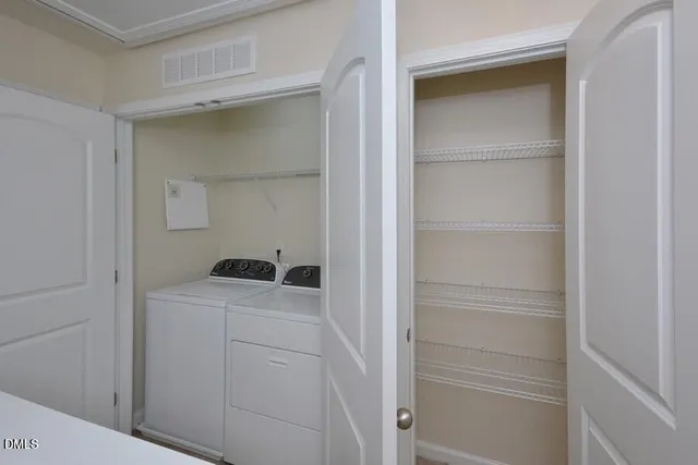 a utility room with cabinets washer and dryer