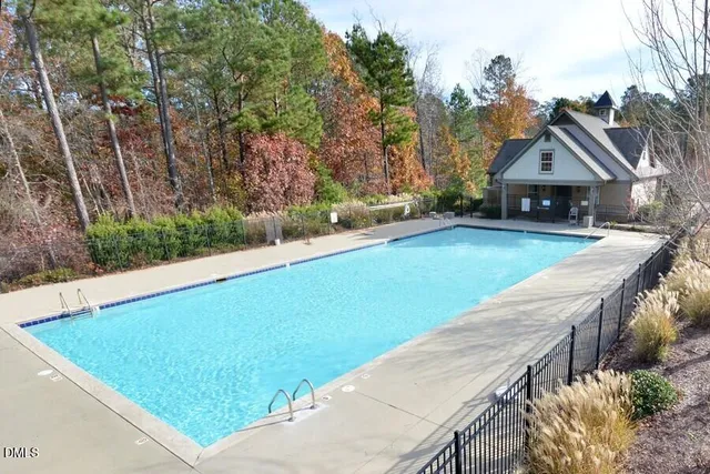 a view of house with backyard and trees