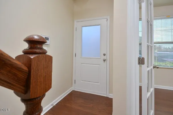 a view of entryway and hall with wooden floor